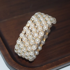 Macro view of multilayer white pearl bracelet featuring crystal rhinestone spacers