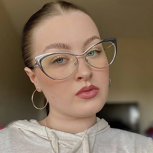 Close-up of a woman wearing silver and black cat eye glasses with metal frames