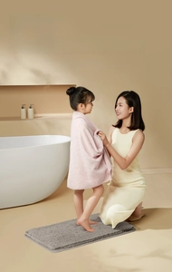Tapis de bain épais en peluche grise montré avec mère et fille pour la sécurité