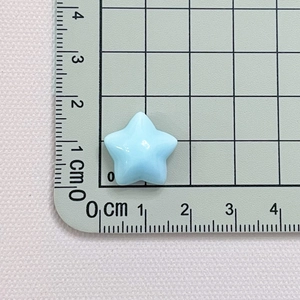 Detailed view of light blue resin star accessory measuring 1.8cm on a measuring mat