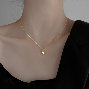 Minimalist S925 sterling silver necklace with a polished gold teardrop pendant on a thin chain