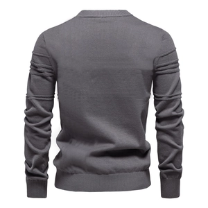 Detail view of the back of a dark gray knit sweater with unique ribbed sleeve textures