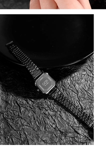 Macro detail of GEDI watch case back with stainless steel screws and matte black strap