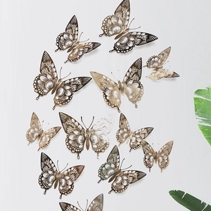 Detailed view of 3D gold hollow metal butterfly wall stickers with intricate cutout patterns