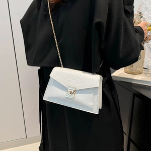 White croc-effect small chain square bag for winter, shown on model with black coat
