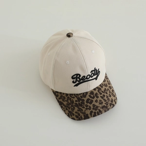 Detail of baseball cap showing Beooty embroidery and leopard print brim on cotton twill