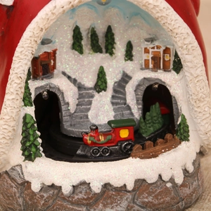 Detailed close-up of a Christmas resin village with a moving train and LED lights