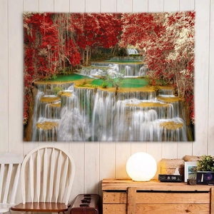 Detail of a landscape wall tapestry showing a vibrant red forest waterfall in a cozy room