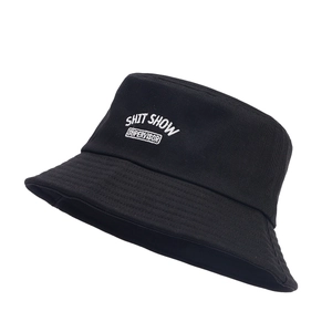 Black cotton bucket hat with white SHIT SHOW SUPERVISOR embroidery on white background