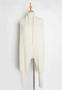 Detail of soft cream white knitted shawl scarf with built-in sleeves for winter warmth