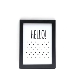 Minimalist black wooden picture frame with HELLO lettering and polka dots art print