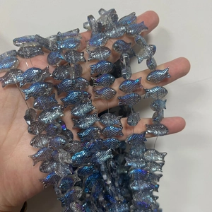 Detail of fish-shaped crystal beads with blue-purple iridescent finish for DIY jewelry
