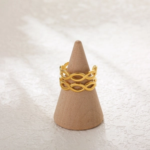 Detailed view of double layered 18K gold plated wave ring on wooden display stand
