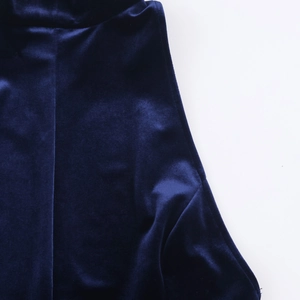 Detailed close-up of dark blue velvet fabric showing rich texture and soft sheen