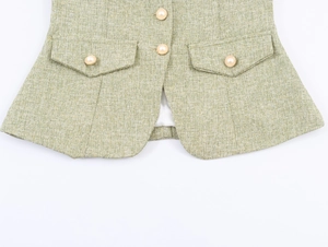 Detail of light green tweed fabric texture with pearl buttons and pocket flaps