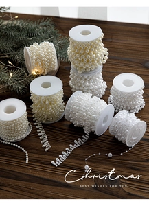 Close-up of ABS pearl bead strands with round and teardrop shapes for Christmas tree decor