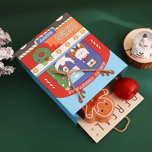 Christmas gift bag with cartoon cat design and gingerbread man tin box inside
