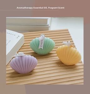 Detailed view of pastel shell scented candles with realistic texture and woven wicks