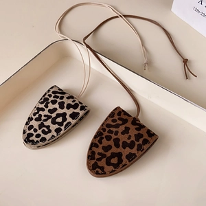 Detail of leopard print faux leather eyeglass cases with magnetic sweater chains
