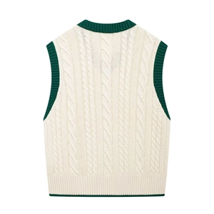 Back view of cream knit vest featuring dark green contrast ribbing and cable pattern