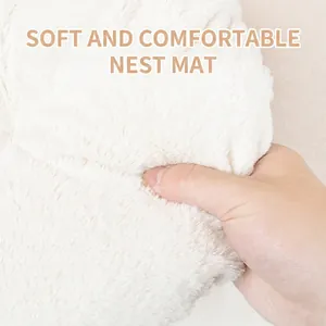 Plush white pet bed mat with soft long faux fur and high elasticity demonstrated by hand