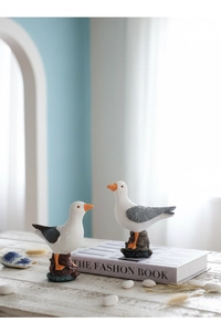 Detail of Nordic resin seagulls on faux rock bases for coastal home decor aesthetics