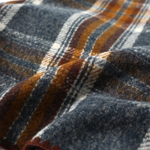 Macro shot of faux cashmere plaid fabric with soft blue, brown, and grey woven textures