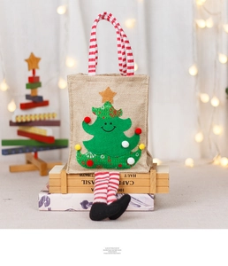 Detail of Christmas tree gift bag featuring long striped legs and soft fabric texture