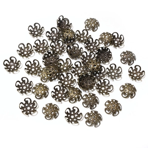 Macro shot of bronze hollow flower bead caps for DIY jewelry making and crafting