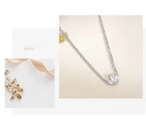 Detail of silver clover pendant necklace with sparkling cubic zirconia on ribbon