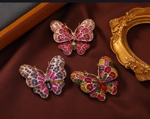Detailed macro view of butterfly brooches with colorful rhinestones on vintage silk