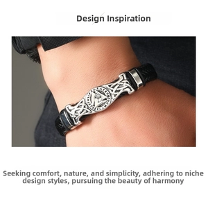 Close-up of black braided leather bracelet with silver Viking Valknut and runes