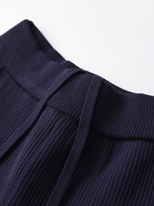 Close-up of navy blue ribbed knit waistband with adjustable drawstring detail
