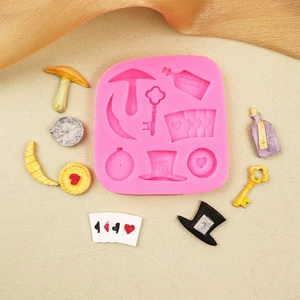 Pink silicone mold featuring magic keys, playing cards, and mushrooms for DIY baking