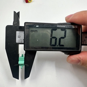 Macro shot of mint green magnetic star clasp showing 6.2mm thickness with digital caliper
