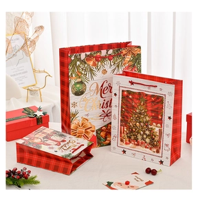 Three sizes of red and green plaid Christmas gift bags on a white table set