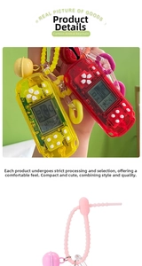 Close-up of retro mini Tetris game consoles with colorful keychains and bells
