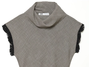 Close-up of the stand collar and houndstooth pattern with delicate lace detailing