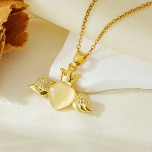 Golden heart wing crown necklace with opal effect and zircon inlay on a stone base