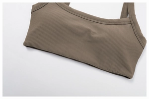 Detail of coffee brown ribbed knit yoga top showing fabric texture and square neckline
