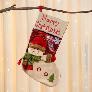 Detail of linen Christmas stocking with Merry Christmas embroidery and snowman applique