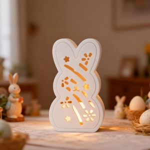 Hollow rabbit night light with floral patterns emitting warm yellow glow for Easter decor