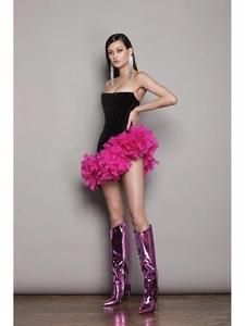 Detail of pink feather trim and black corset waist on asymmetrical party dress
