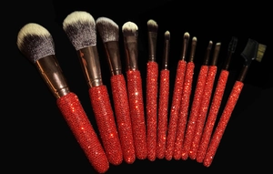 Detail of 12-piece makeup brush set featuring sparkling red rhinestone-encrusted handles