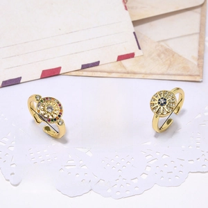 Detailed view of adjustable copper rings with cubic zirconia and boho eye charms
