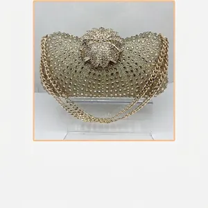 Luxurious gold evening clutch bag with sparkling rhinestones and floral clasp detail