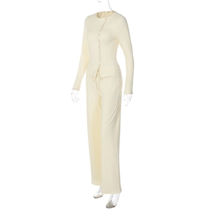 Detail view of cream ribbed knit fabric texture on cardigan and wide-leg pants set