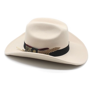 Detail of cream felt fedora hat with black band, gold buckle and natural feather accent