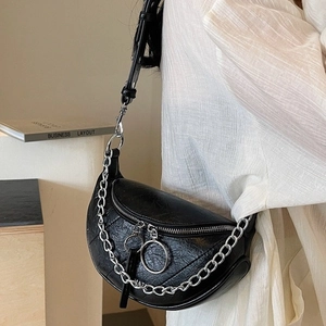 Vintage black quilted PU leather crossbody bag with silver chain strap on white shirt