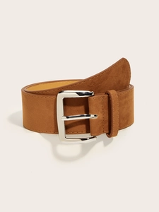 Close-up of brown suede belt with silver metal buckle on neutral background